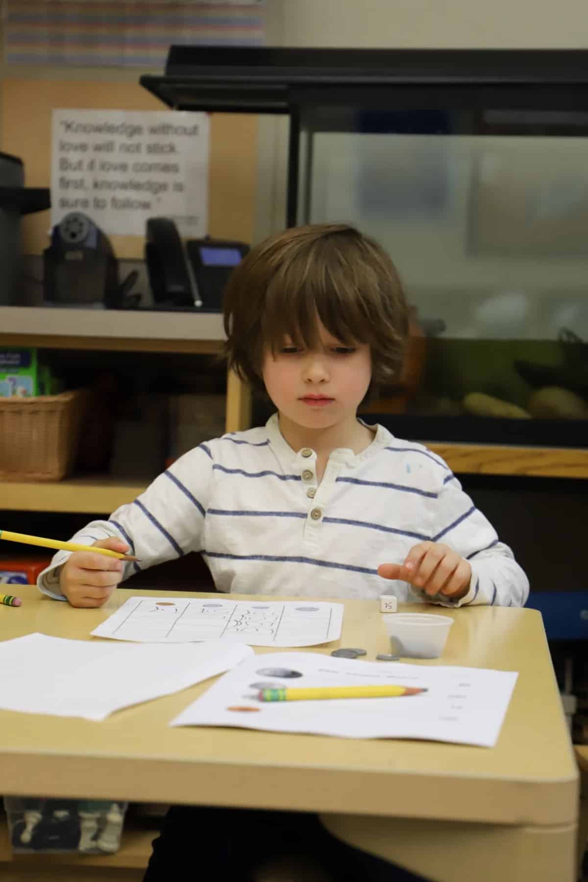 Student uses chart to count money