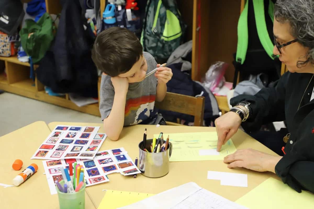 Student works with teacher on creating stamps