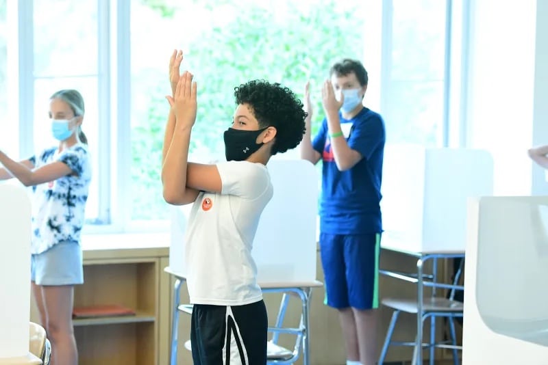 Students practice mindfulness together through stretching activity